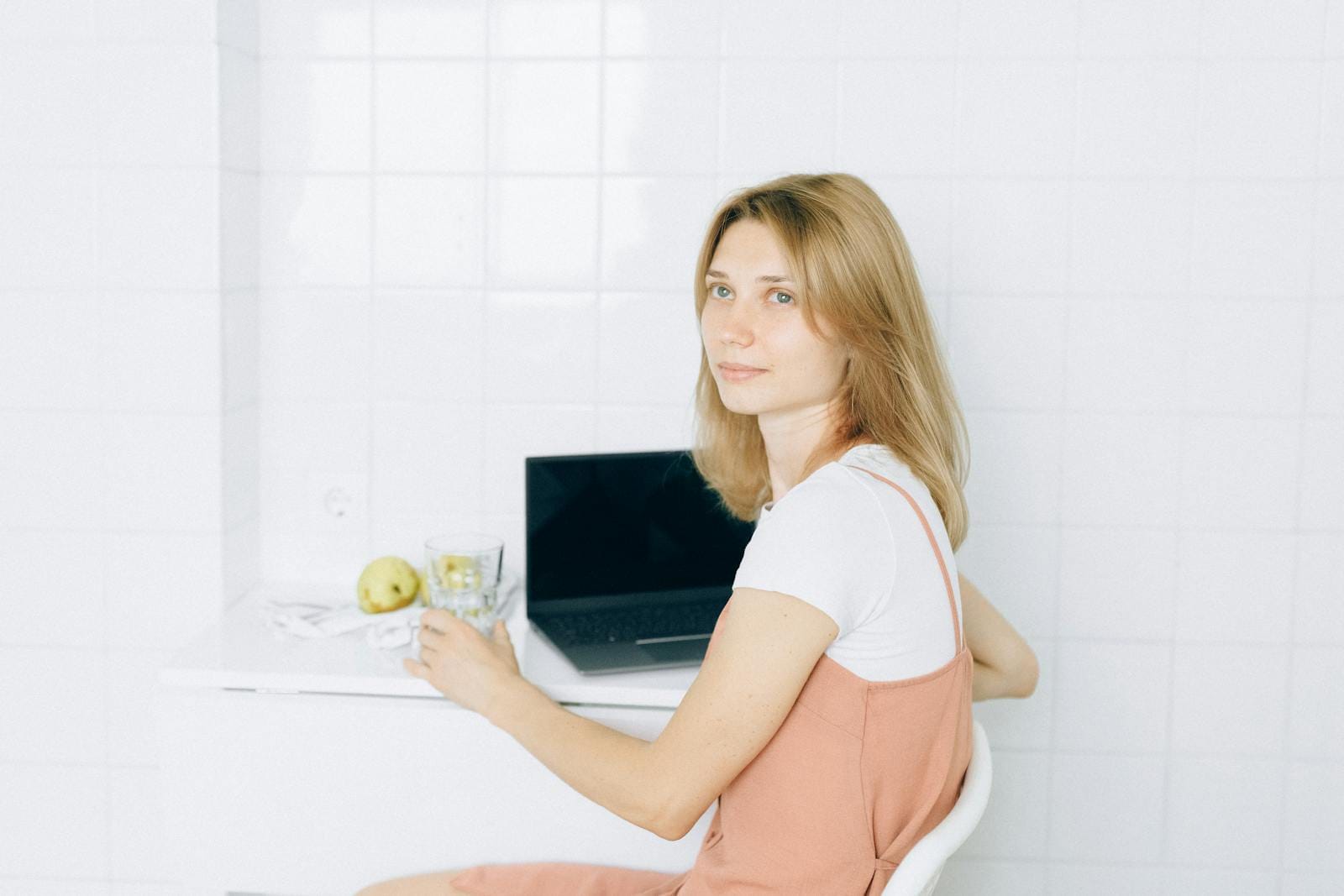 Woman working from home using laptop, illustrating modern remote lifestyle