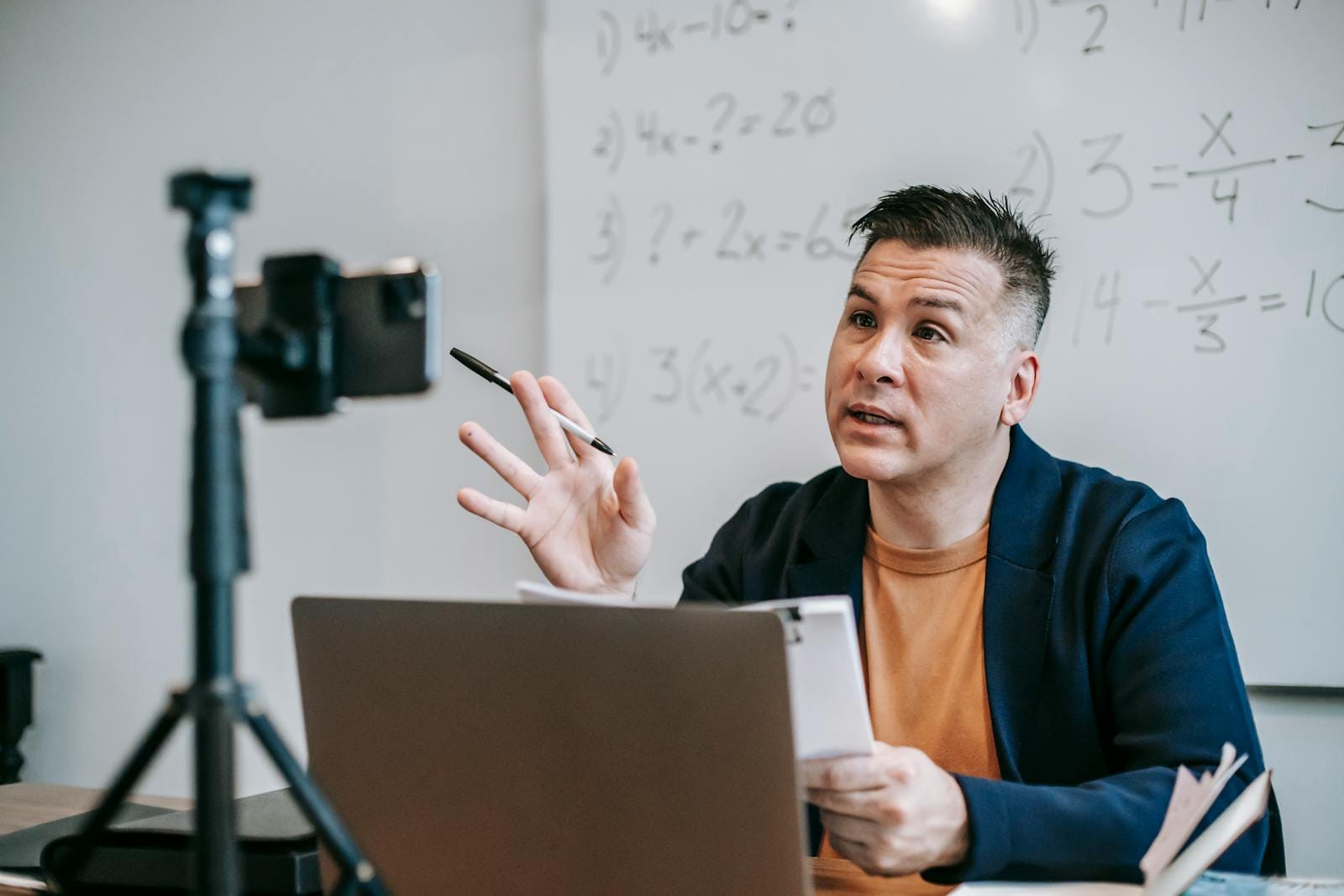 Instructor teaching online using laptop and webcam in virtual classroom