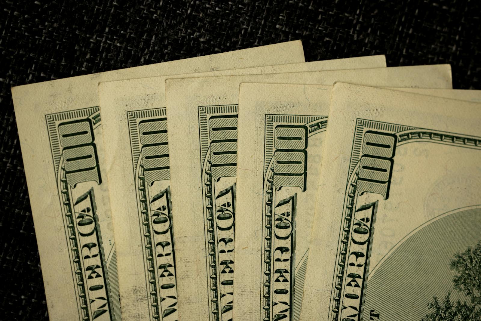 Stack of one hundred dollar bills, illustrating saved earnings