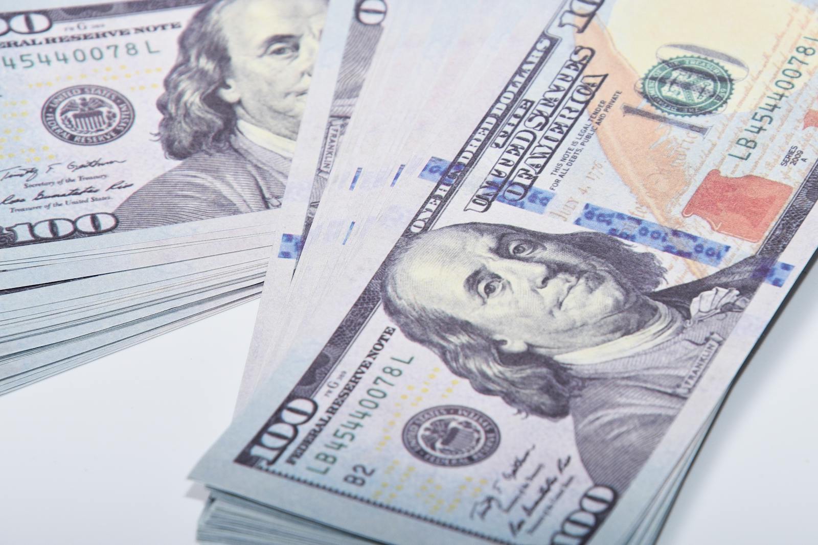 Stacked US 100 dollar banknotes, illustrating wealth and finance