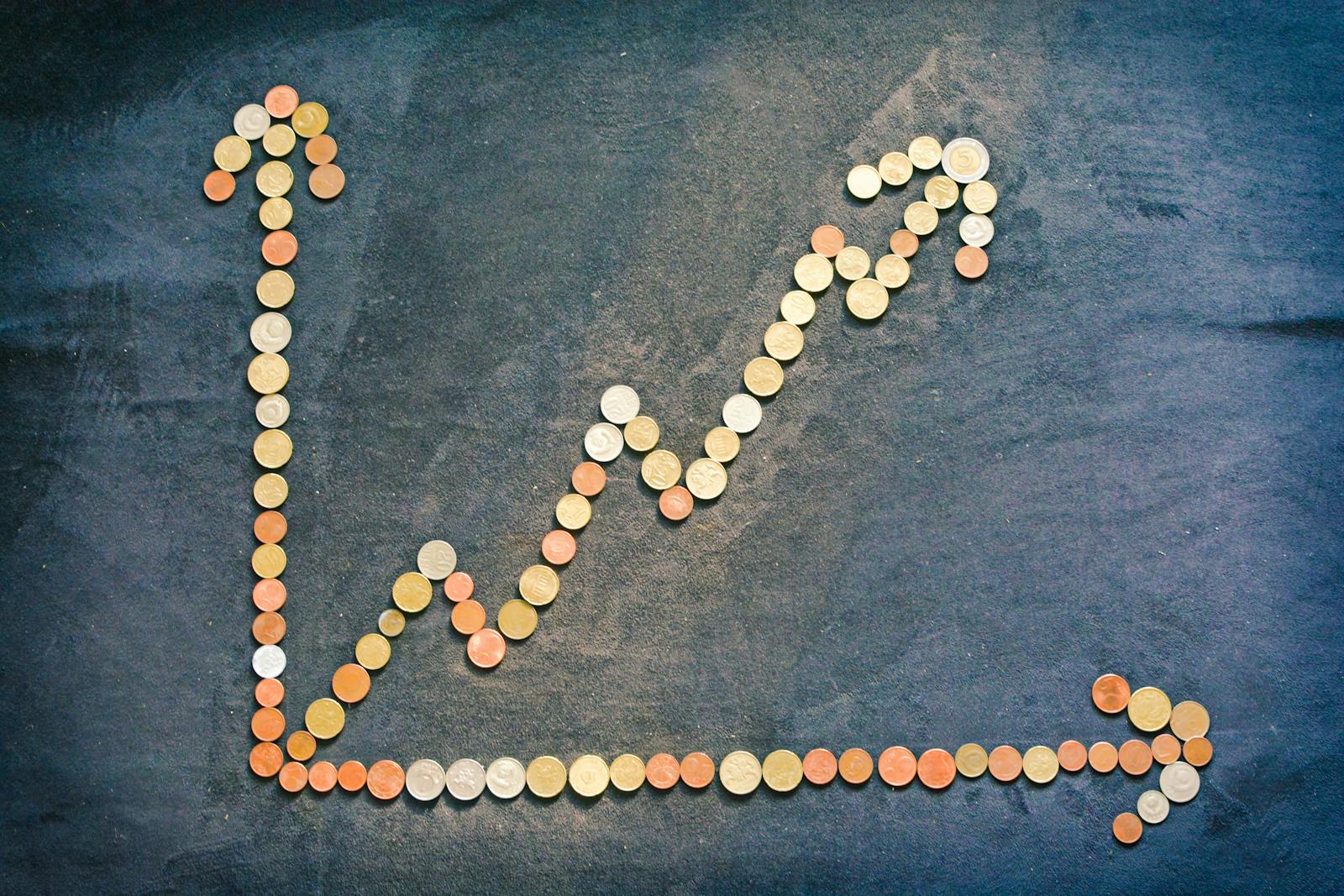 Upward trend graph made from coins, illustrating financial growth