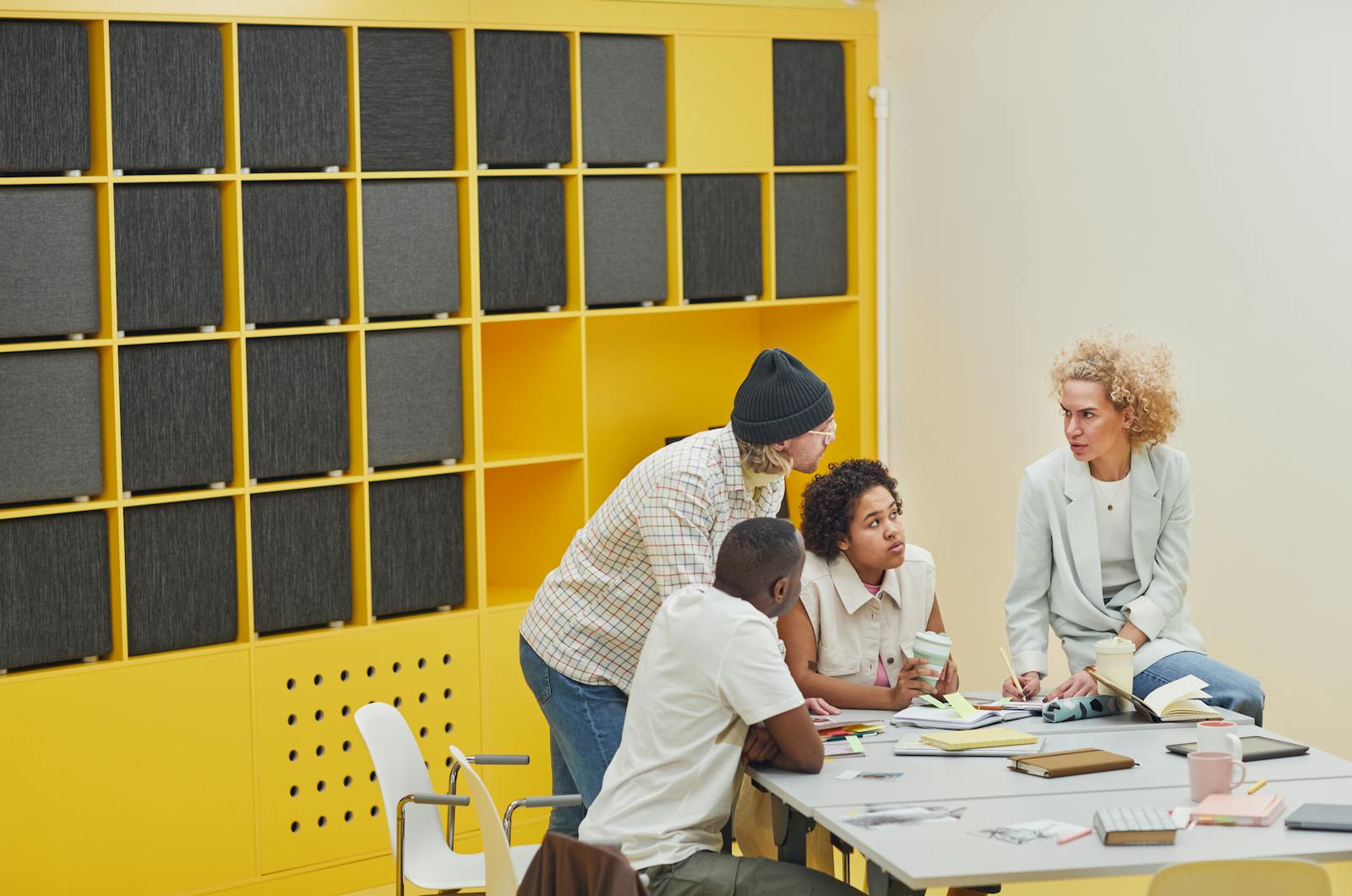 Colleagues in collaborative meeting in modern colorful office space