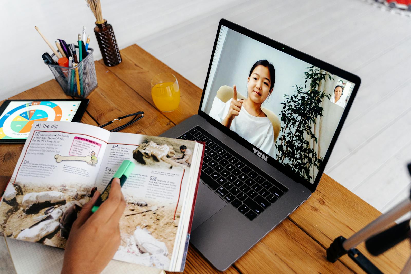Online teaching session with woman on laptop screen, illustrating digital education for creators
