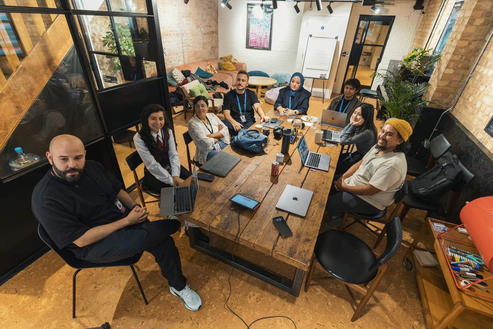 Diverse professionals collaborating in modern office with laptops