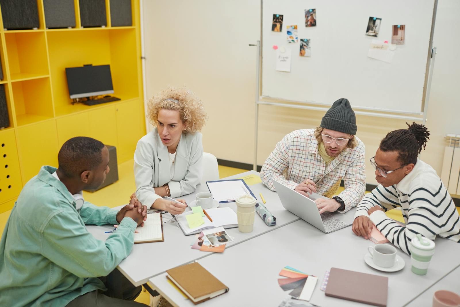 Diverse colleagues discussing ideas in bright modern office setting