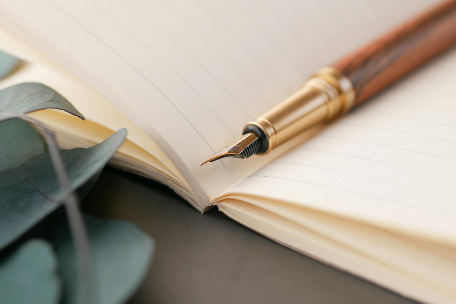 Fountain pen resting on lined notebook, illustrating writing process
