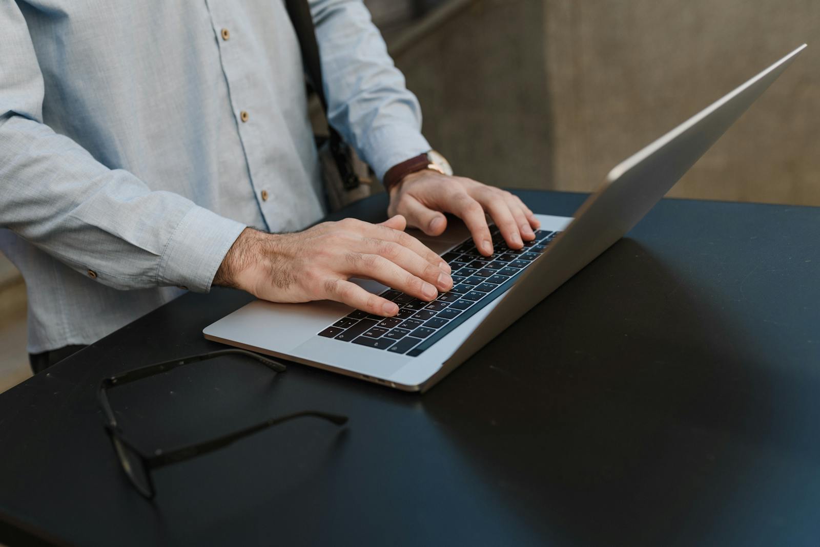 Close-up of hands typing on laptop, illustrating business work imagery