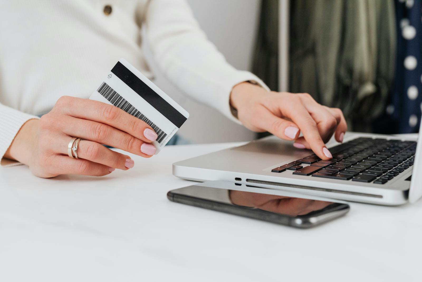 Woman using credit card for online transaction on laptop