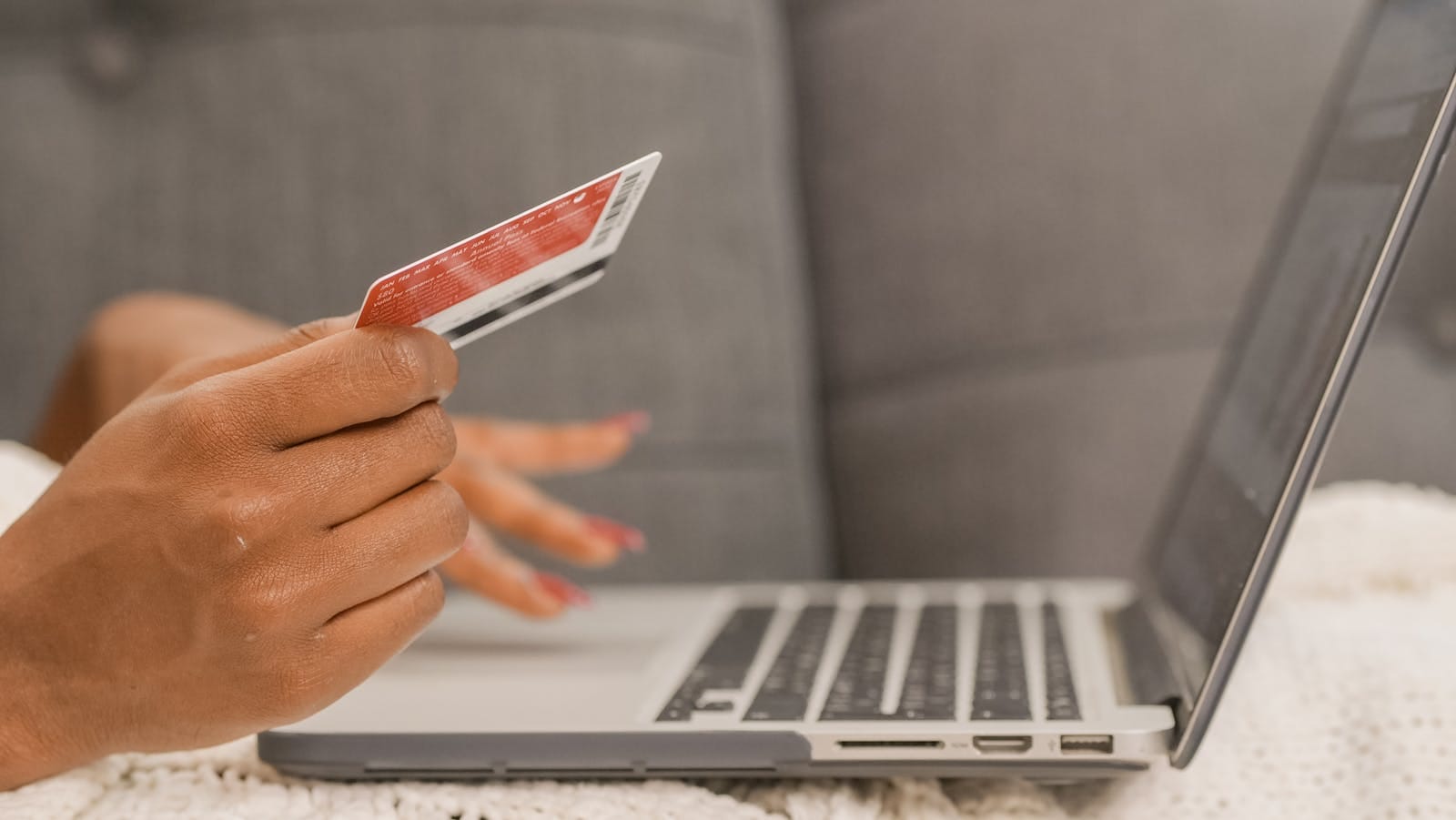 Close-up of credit card use for online shopping on laptop