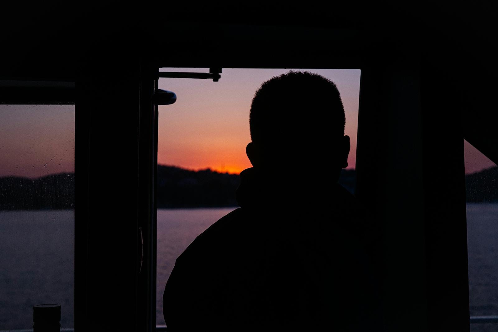 Silhouette looking at sunset over sea, illustrating aspiration and goals