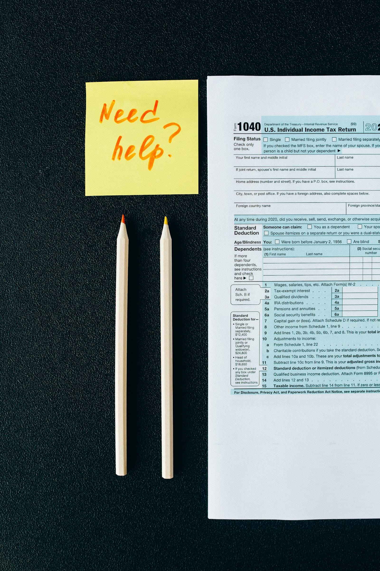 Tax forms calculator and pen on desk, illustrating creator income tax management