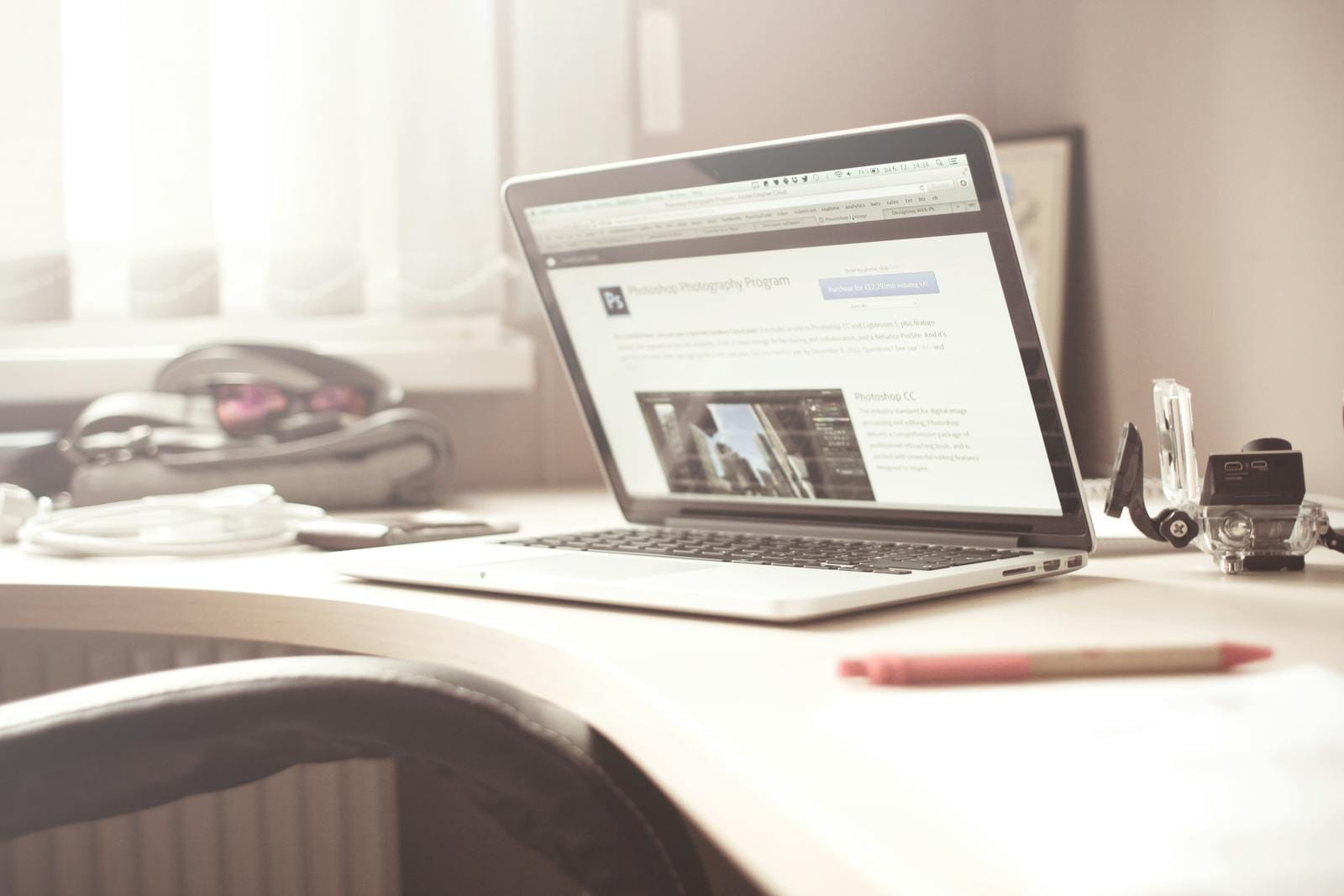 Clean and bright workspace featuring open laptop on wooden desk