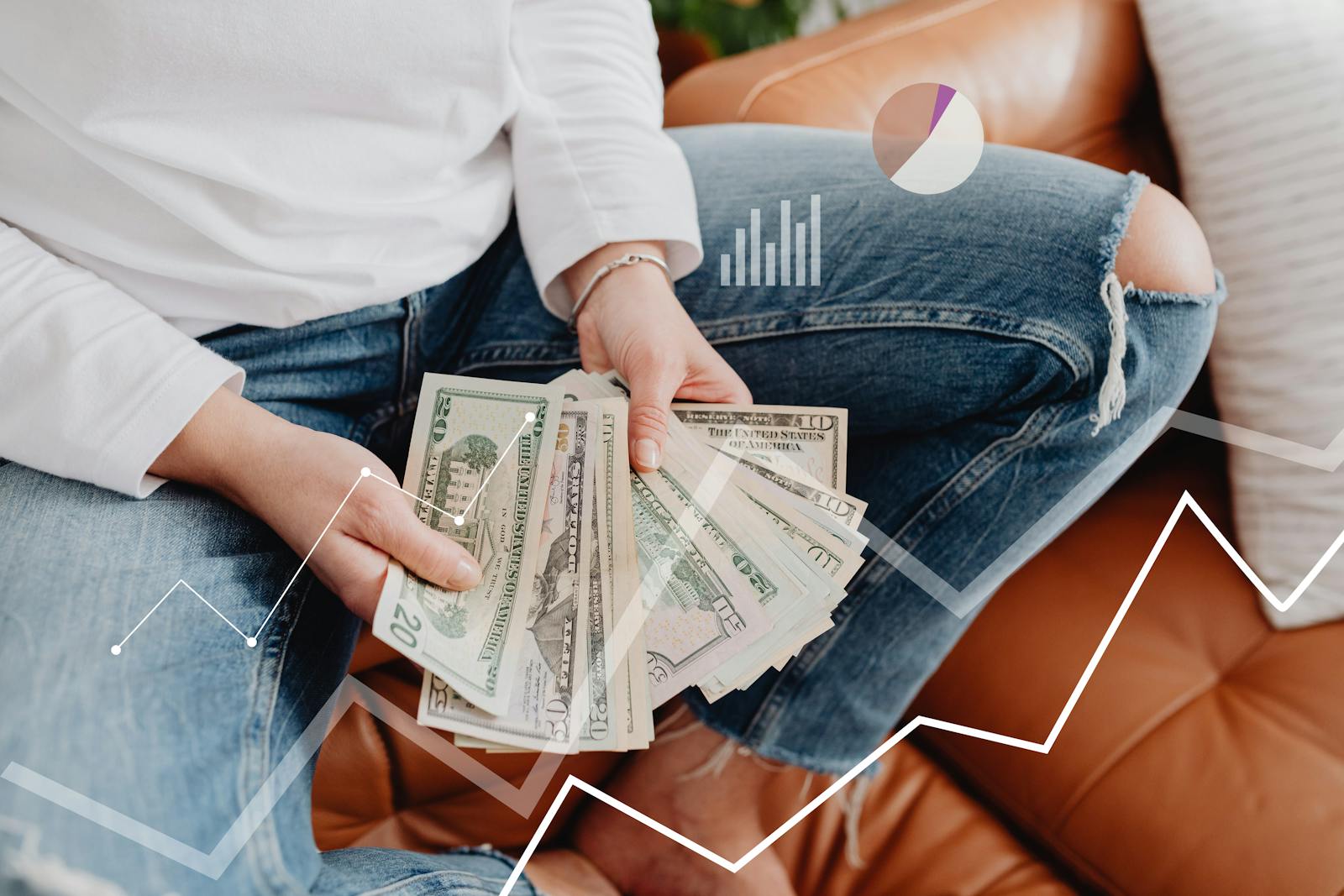 Person with dollars in hand, sitting, financial graphics overlay showing growth